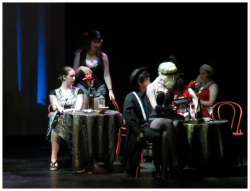 (Image: Cabaret Girl Katherine Sits on the
   Lap of Crime Boss Thomas in the Nightclub)
