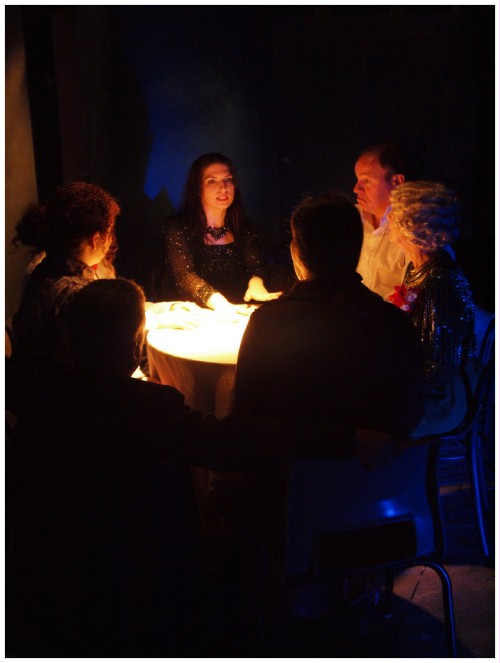 (Image: View of the Actors at the Seance Table from a
   Slightly Downward Angle)