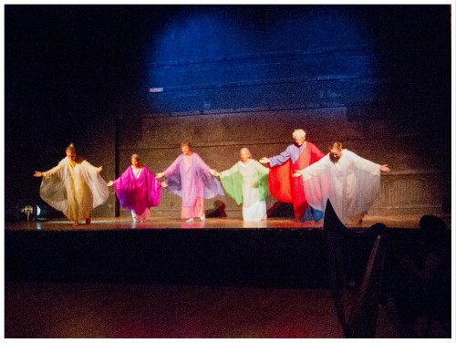 (Image: Dancers Lower their Arms
  while Bowing Their Heads)