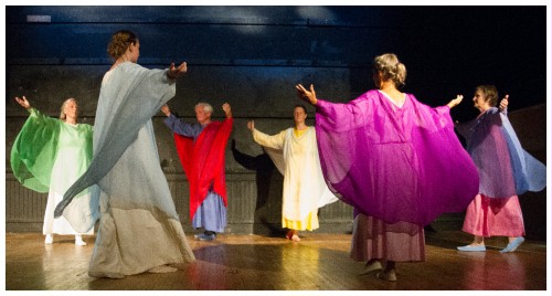 (Image: Dancers Circle with Clouds Projected Behind)