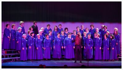 (Image: The Female Chorus on the Risers Dressed in Blue)