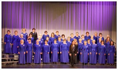 (Image: The Female Chorus on the Risers Dressed in Blue)