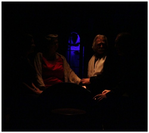 (Image: A Ghost Appears while Guests are
   at the Seance Table in Dim Lighting.)