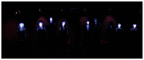 (Image: Dancers in a Row with LED Light on their Faces)