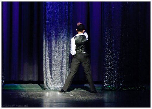 (Image: A Single Dancer is seen Back On at the Upstage Drape)