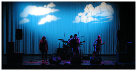 (Image: Clouds and a Blue Sky Silhouette the Band)