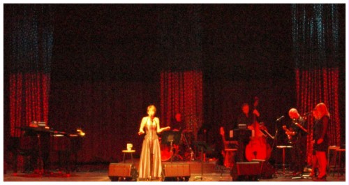 (Image: `Patsy' is again Highlighted in White while
  the Band Performs around Her)