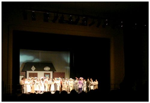 (Image: Long Shot of the Stage with
 the Majority of the Cast)