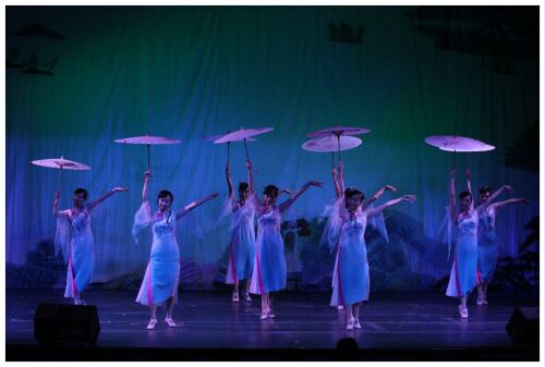 (Image: Eight Dancers Dressed in White Chiffon Hold Parasols
  Aloft)