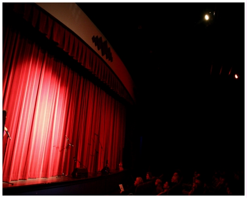 (Image: The Bella Rose Stage with Closed, Red Curtain)