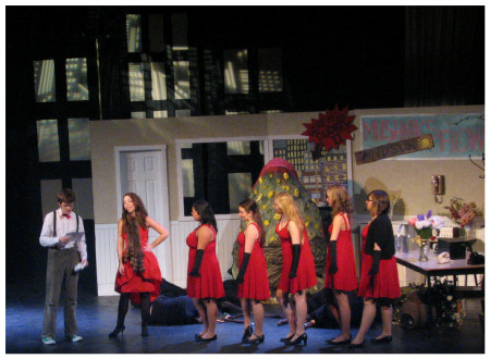 (Image: The Chorus in Red Dresses Confers with Seymore)