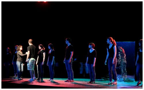 (Image: The Cast is Lined up Downstage, while
 one Member Goes to Each in Turn)
